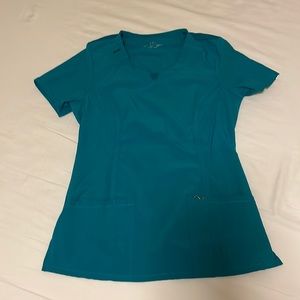 Cherokee Infinity Scrub Top in teal blue. Round neck top.